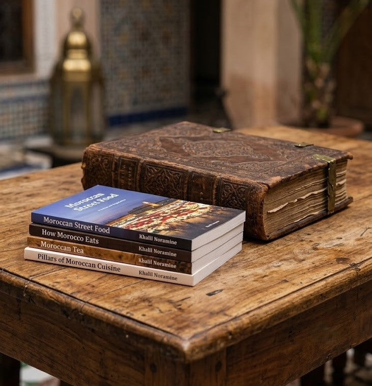 Moroccan culinary heritage ebooks beside an antique Moroccan book